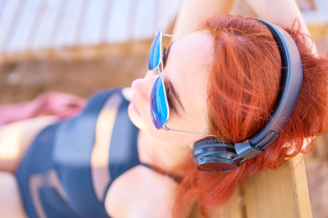 56946964_beautiful-woman-in-sunglasses-listening-to-music-on-the-beach-Medium.jpeg